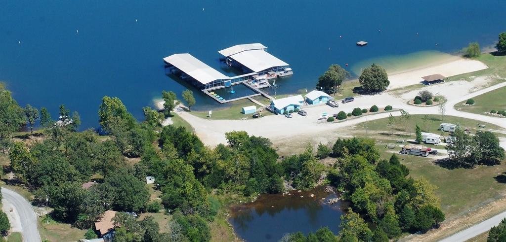 an aerial view of a house with a yard and lake view