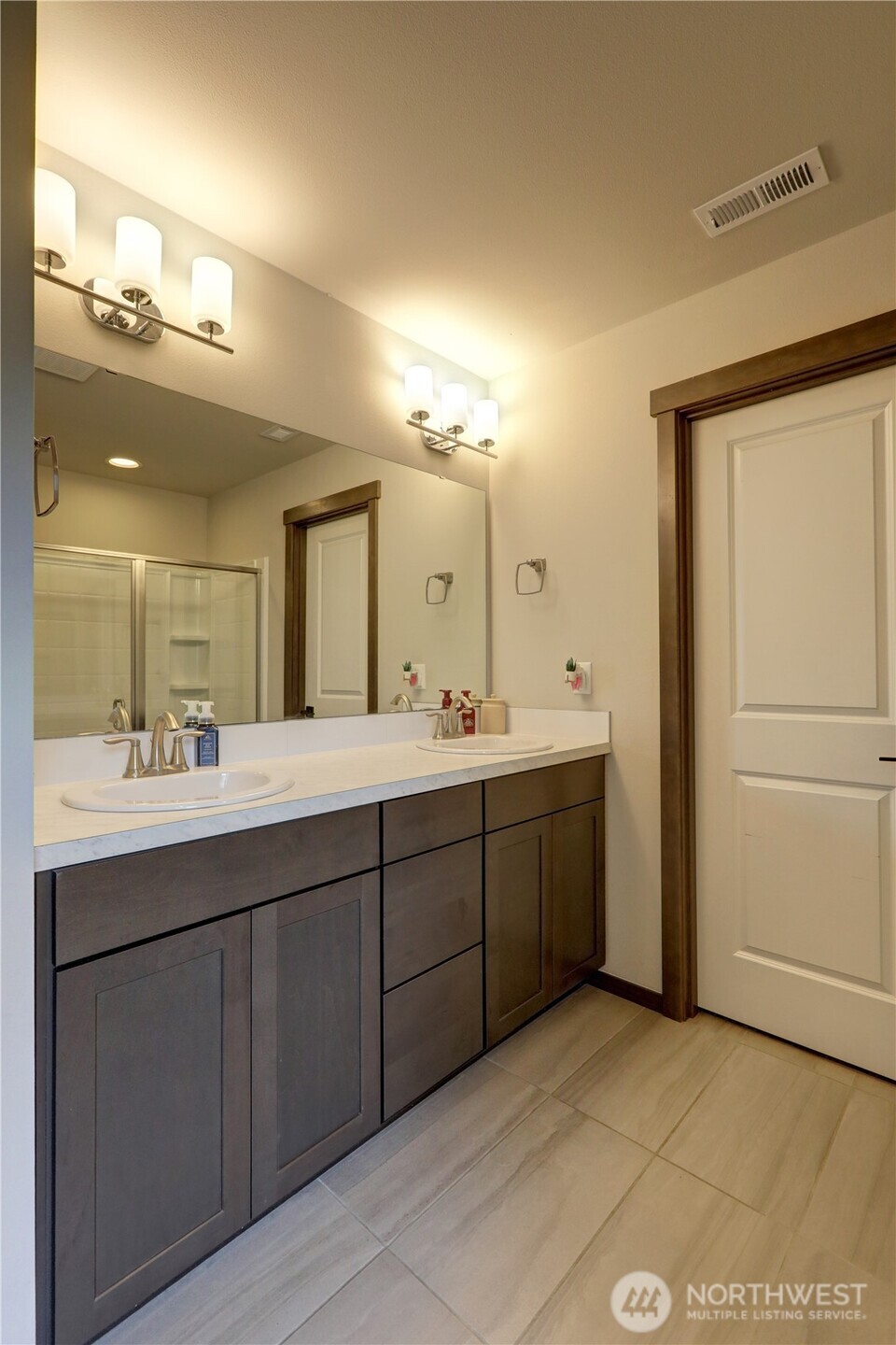 5154 Granger Street Bremerton, WA 98312 - Photo 16 of 26 a bathroom with a double vanity sink and a mirror