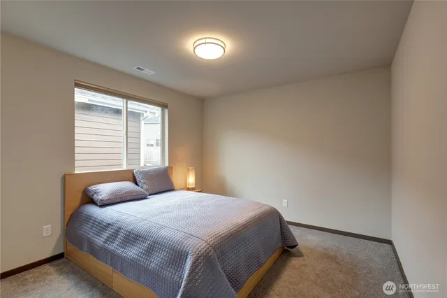 a bedroom with a bed and window