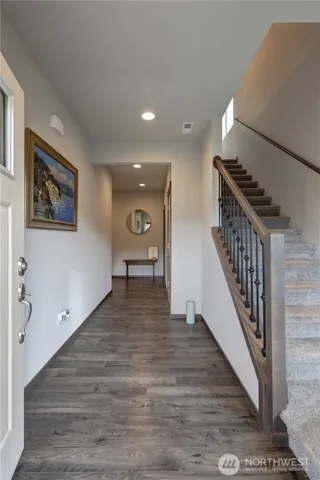 a view of a hallway with wooden floor