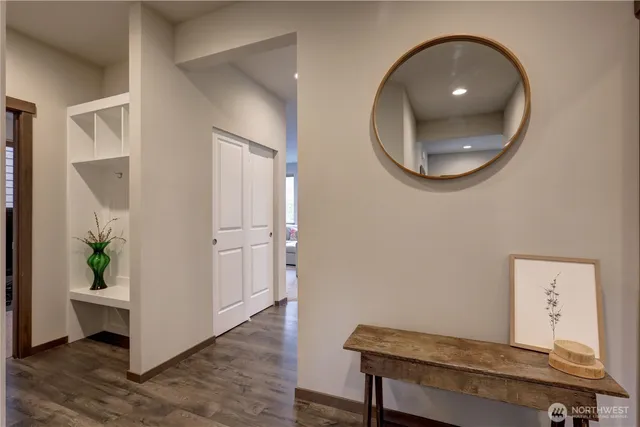 wooden floor with a potted plant and a mirror
