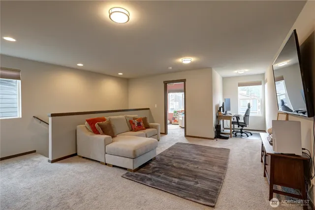 a living room with furniture a flat screen tv and a table