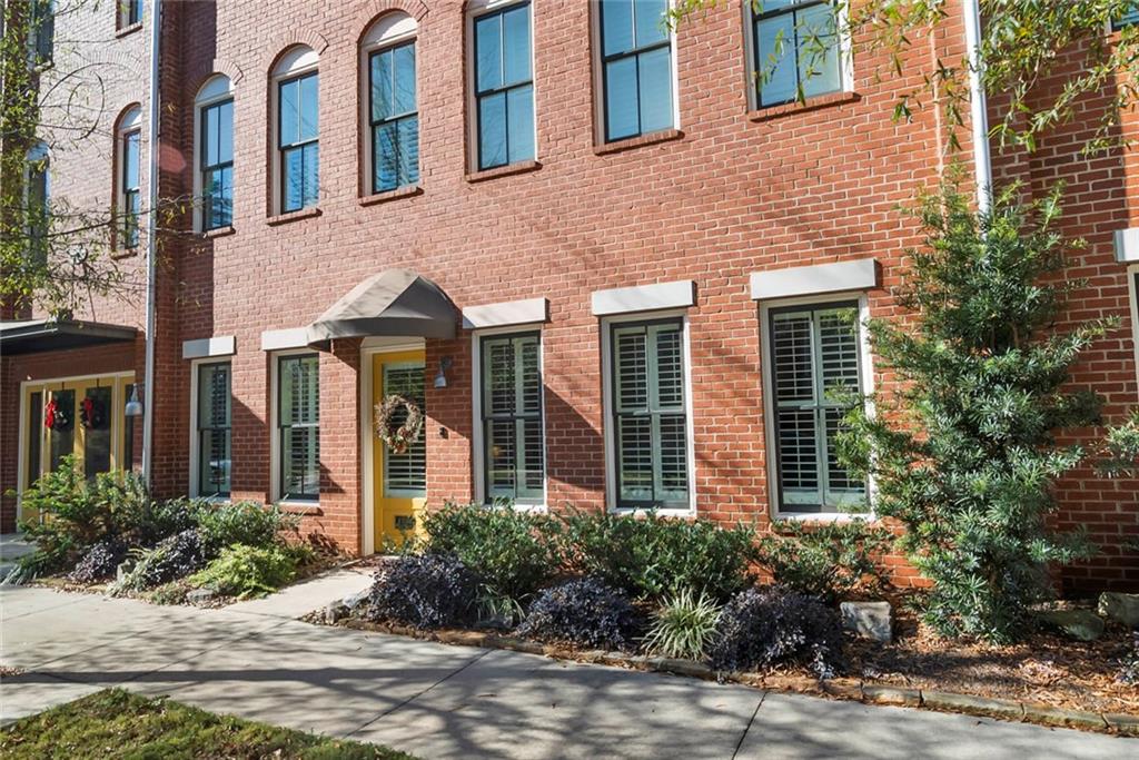 a view of a brick building next to a yard