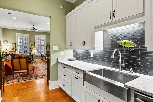 a kitchen with stainless steel appliances a stove a sink a counter space and cabinets