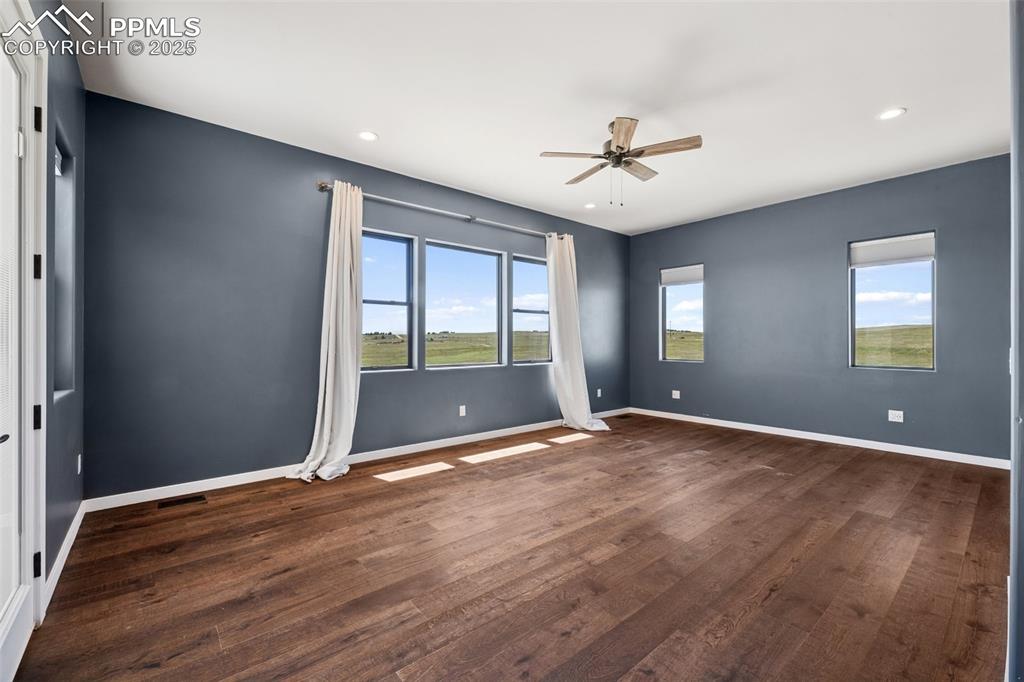24365 Murphy Road Calhan, CO 80808 - Photo 21 of 48 a view of an empty room with window and wooden floor