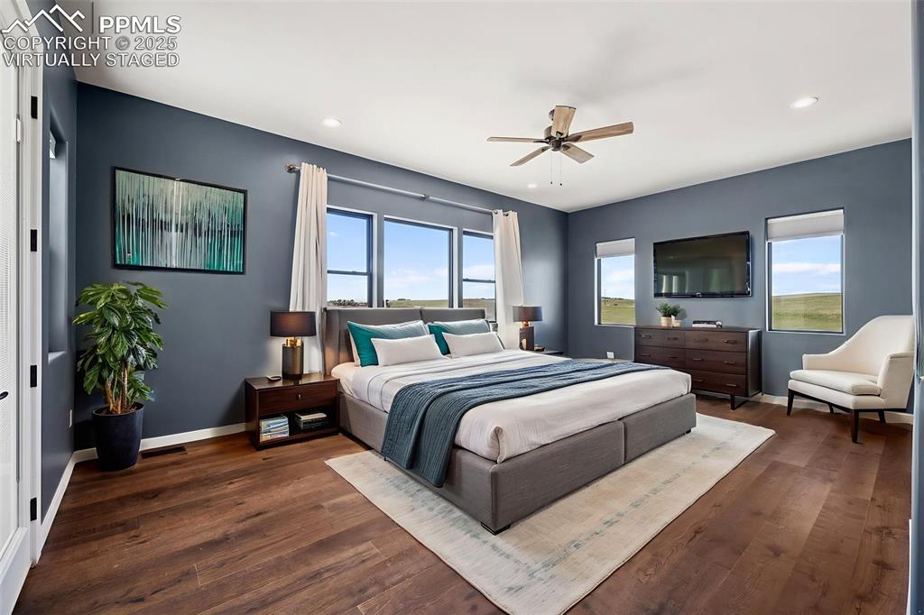 24365 Murphy Road Calhan, CO 80808 - Photo 22 of 48 a bedroom with a bed couch and wooden floor