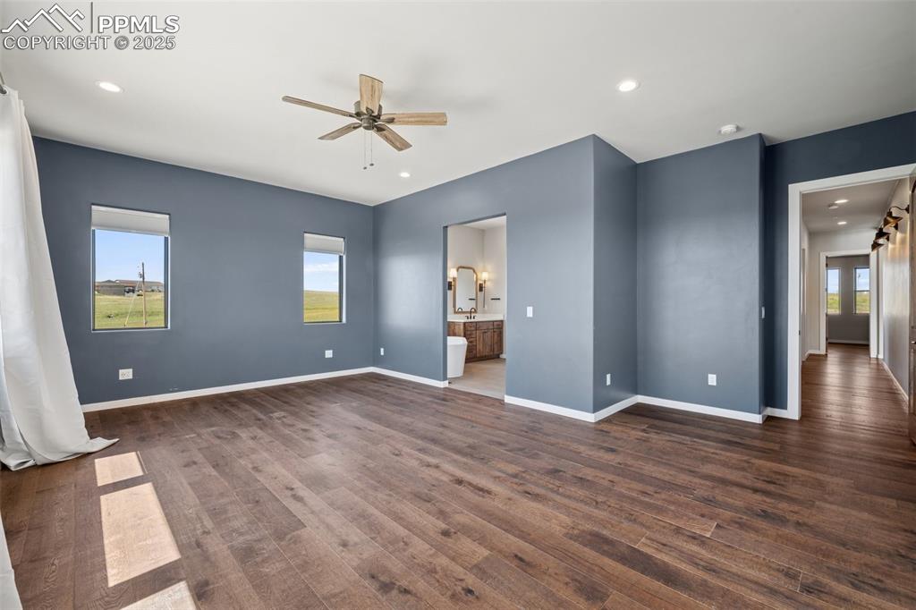24365 Murphy Road Calhan, CO 80808 - Photo 23 of 48 a view of an empty room with wooden floor and a ceiling fan