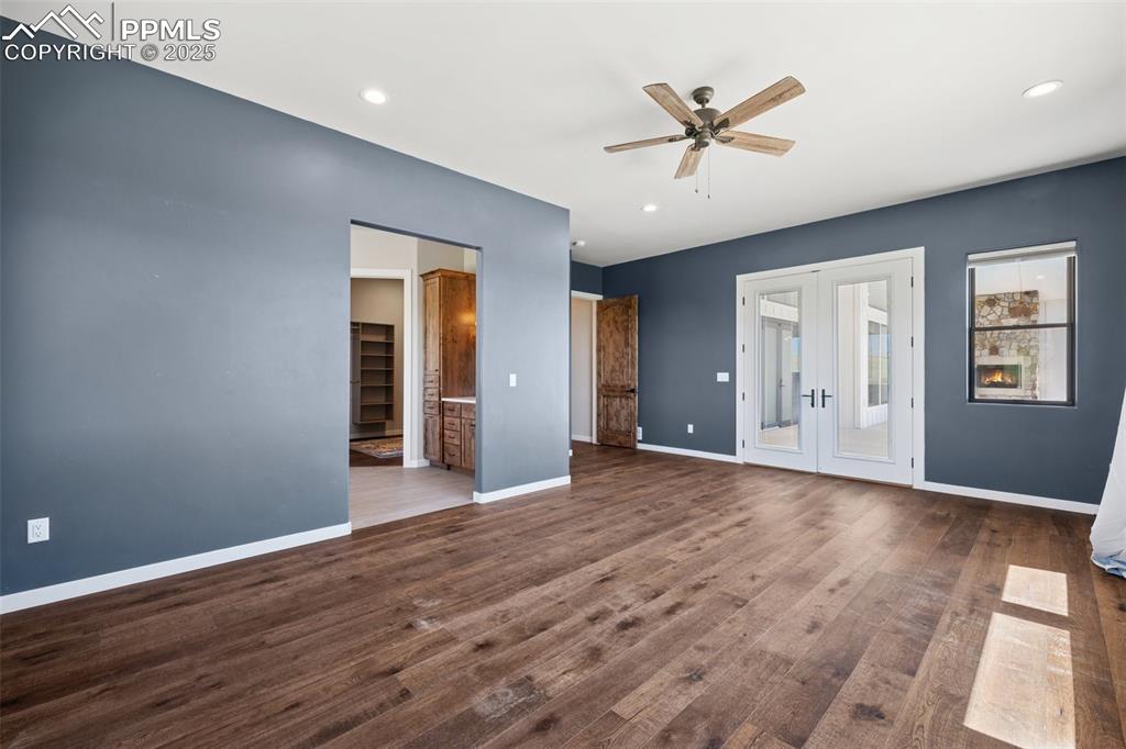24365 Murphy Road Calhan, CO 80808 - Photo 24 of 48 Unfurnished bedroom with french doors, dark wood finished floors, recessed lighting, access to outside, and ceiling fan