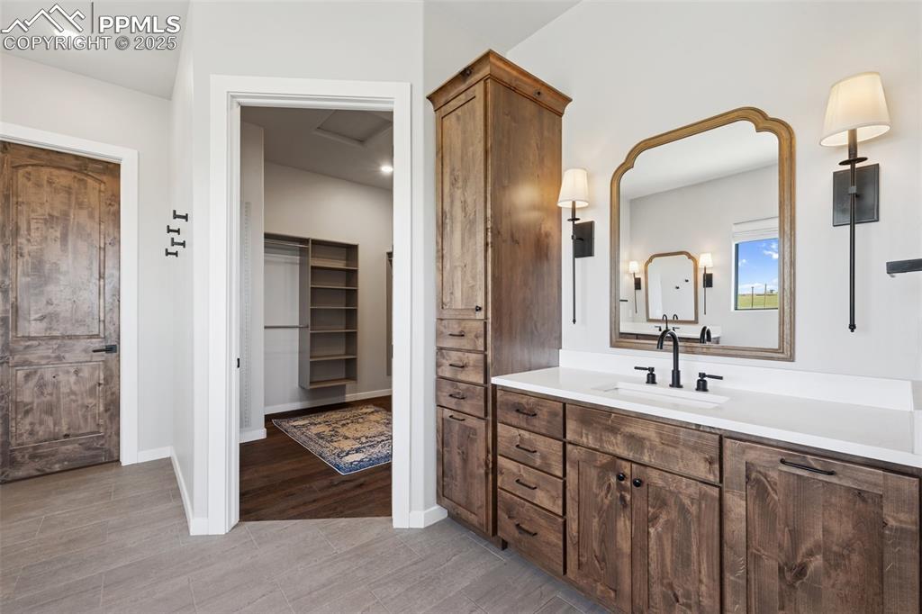 24365 Murphy Road Calhan, CO 80808 - Photo 27 of 48 a en suite bathroom with a double vanity sink and a mirror