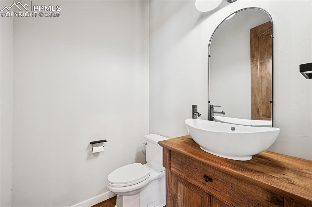 24365 Murphy Road Calhan, CO 80808 - Photo 30 of 48 a bathroom with a sink a toilet and mirror