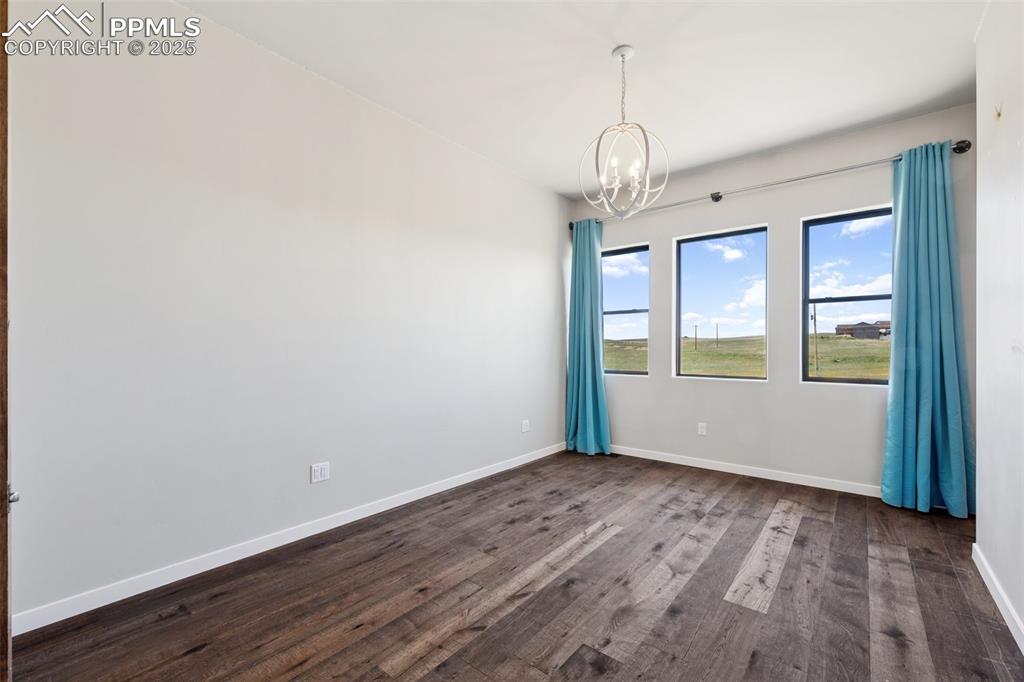 24365 Murphy Road Calhan, CO 80808 - Photo 36 of 48 a view of an empty room with wooden floor and windows