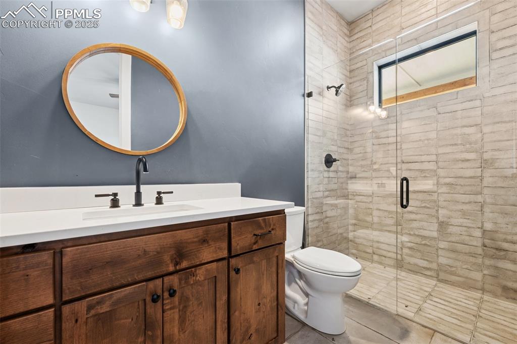24365 Murphy Road Calhan, CO 80808 - Photo 38 of 48 a bathroom with a toilet a sink and mirror