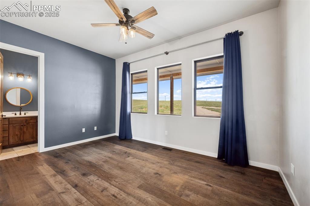 24365 Murphy Road Calhan, CO 80808 - Photo 39 of 48 Unfurnished bedroom with wood finished floors and ensuite bathroom