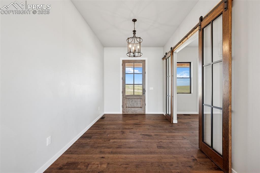 24365 Murphy Road Calhan, CO 80808 - Photo 6 of 48 a view of an entryway with wooden floor and windows