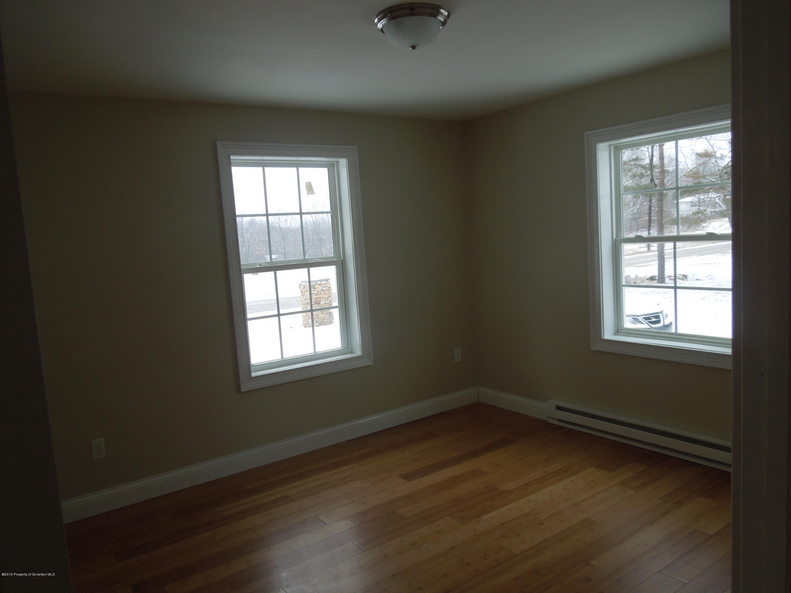 474 Fairview Road Dalton, PA 18414 - Photo 16 of 21 an empty room with wooden floor and windows