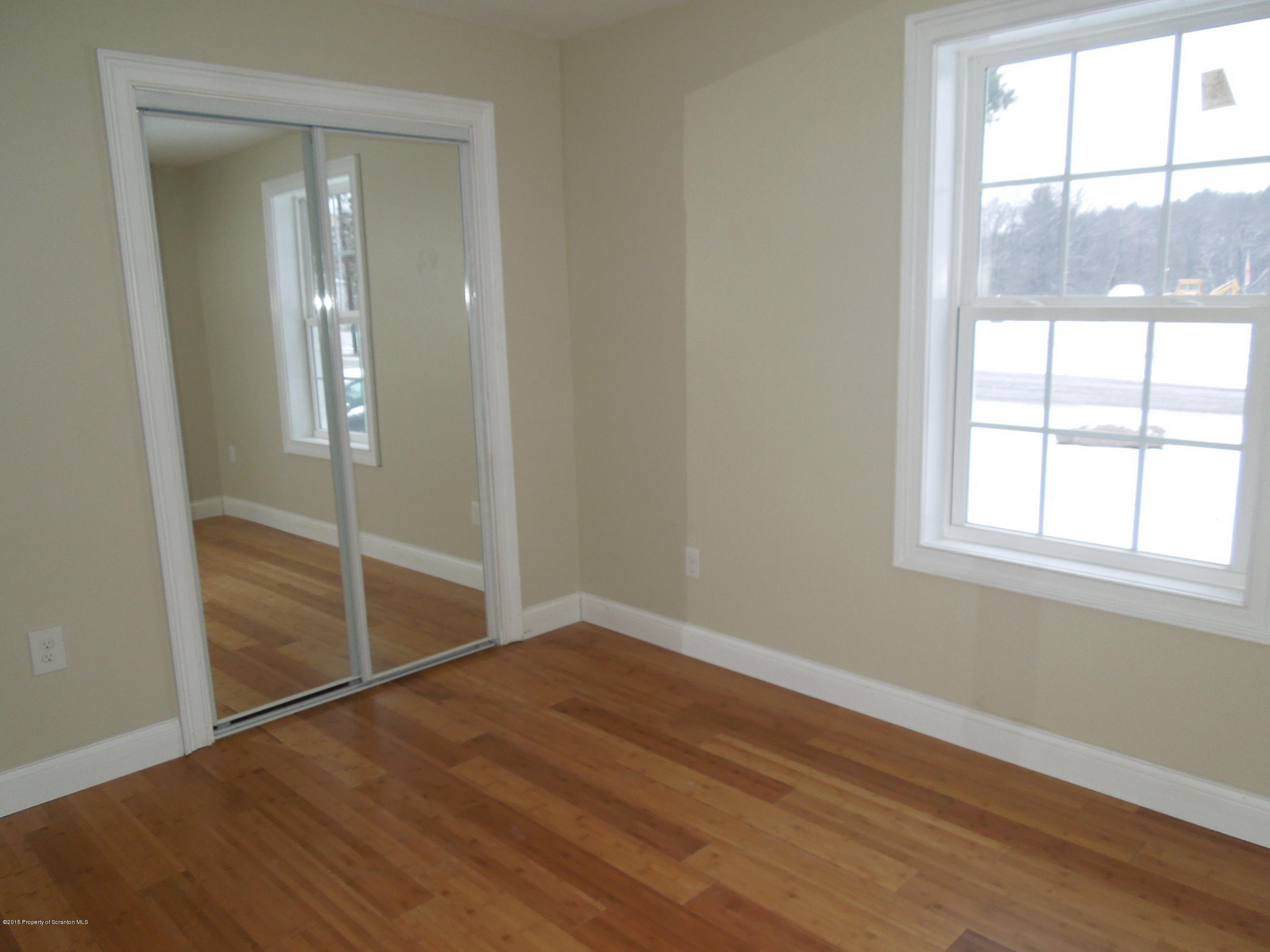 474 Fairview Road Dalton, PA 18414 - Photo 17 of 21 an empty room with wooden floor and windows