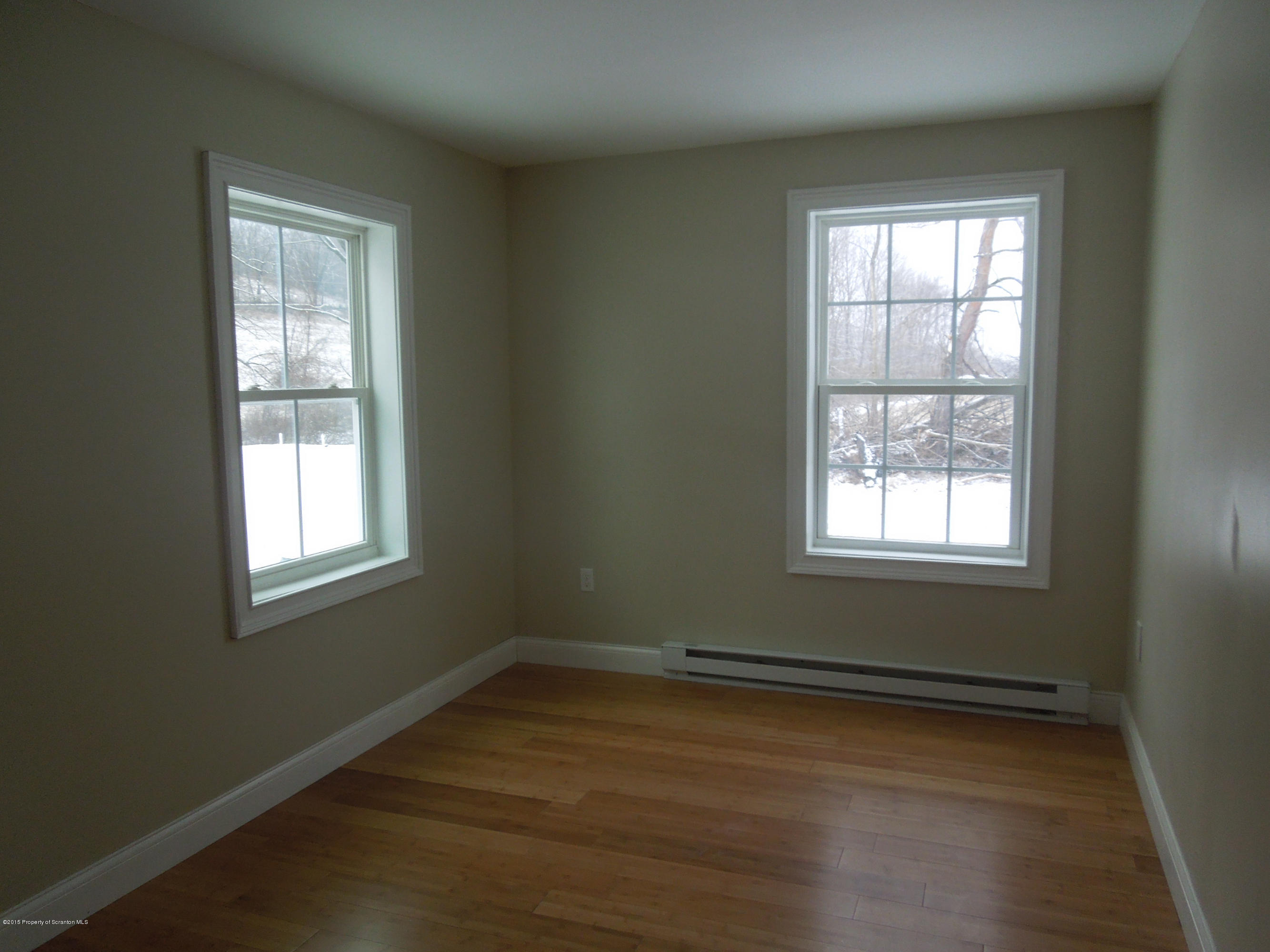 474 Fairview Road Dalton, PA 18414 - Photo 18 of 21 an empty room with wooden floor and windows