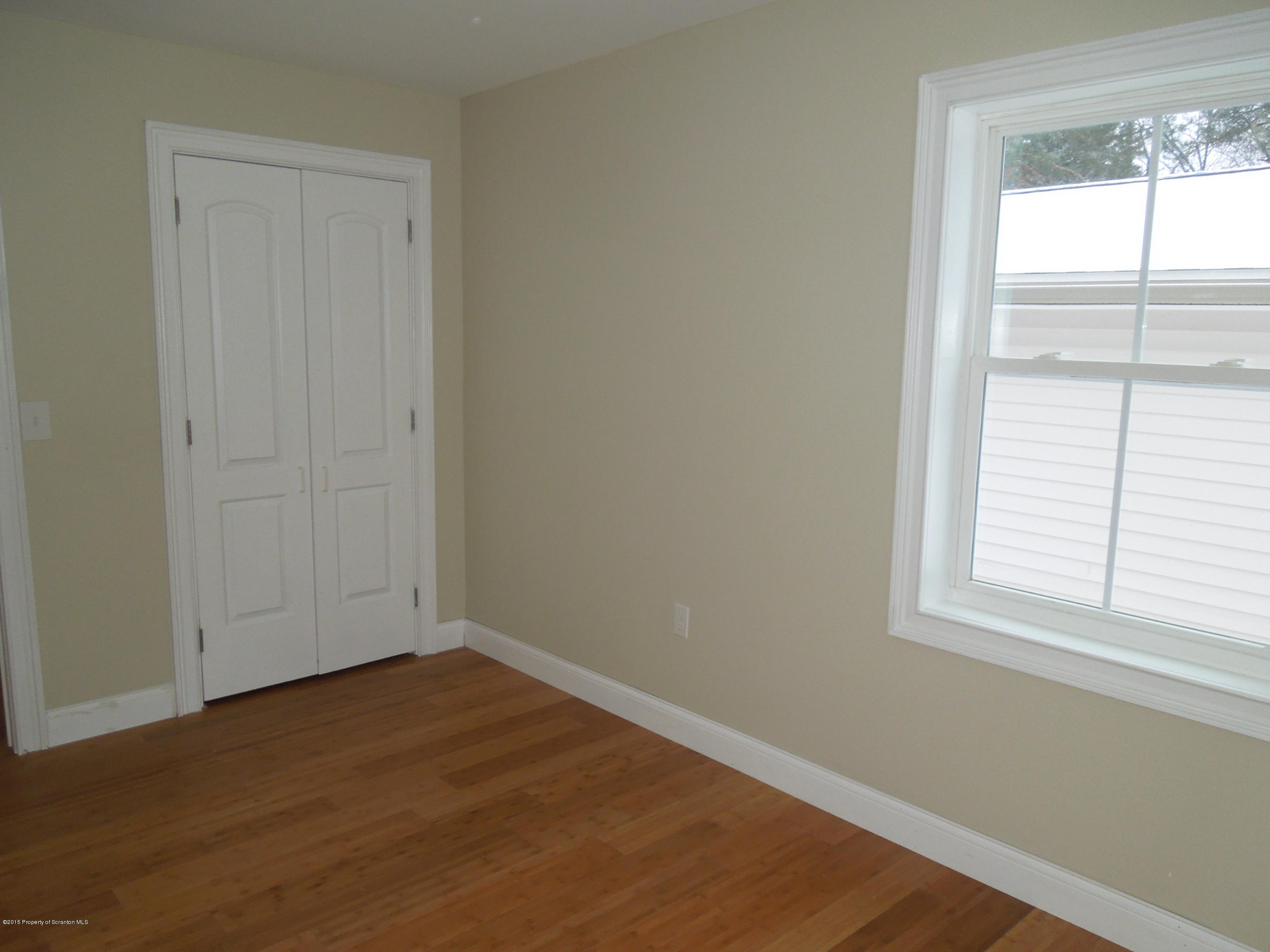 474 Fairview Road Dalton, PA 18414 - Photo 19 of 21 an empty room with wooden floor and windows