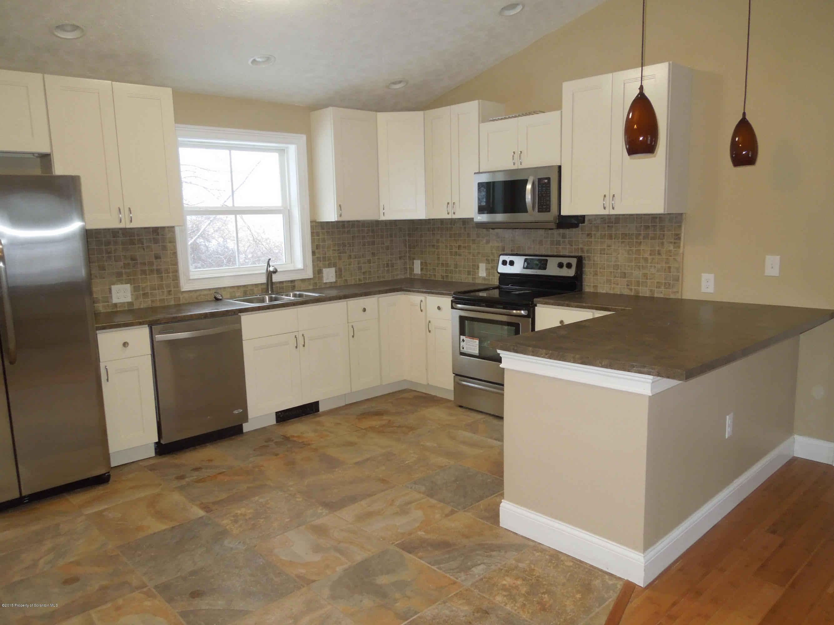 474 Fairview Road Dalton, PA 18414 - Photo 5 of 21 a kitchen with stainless steel appliances granite countertop a stove a sink and a microwave