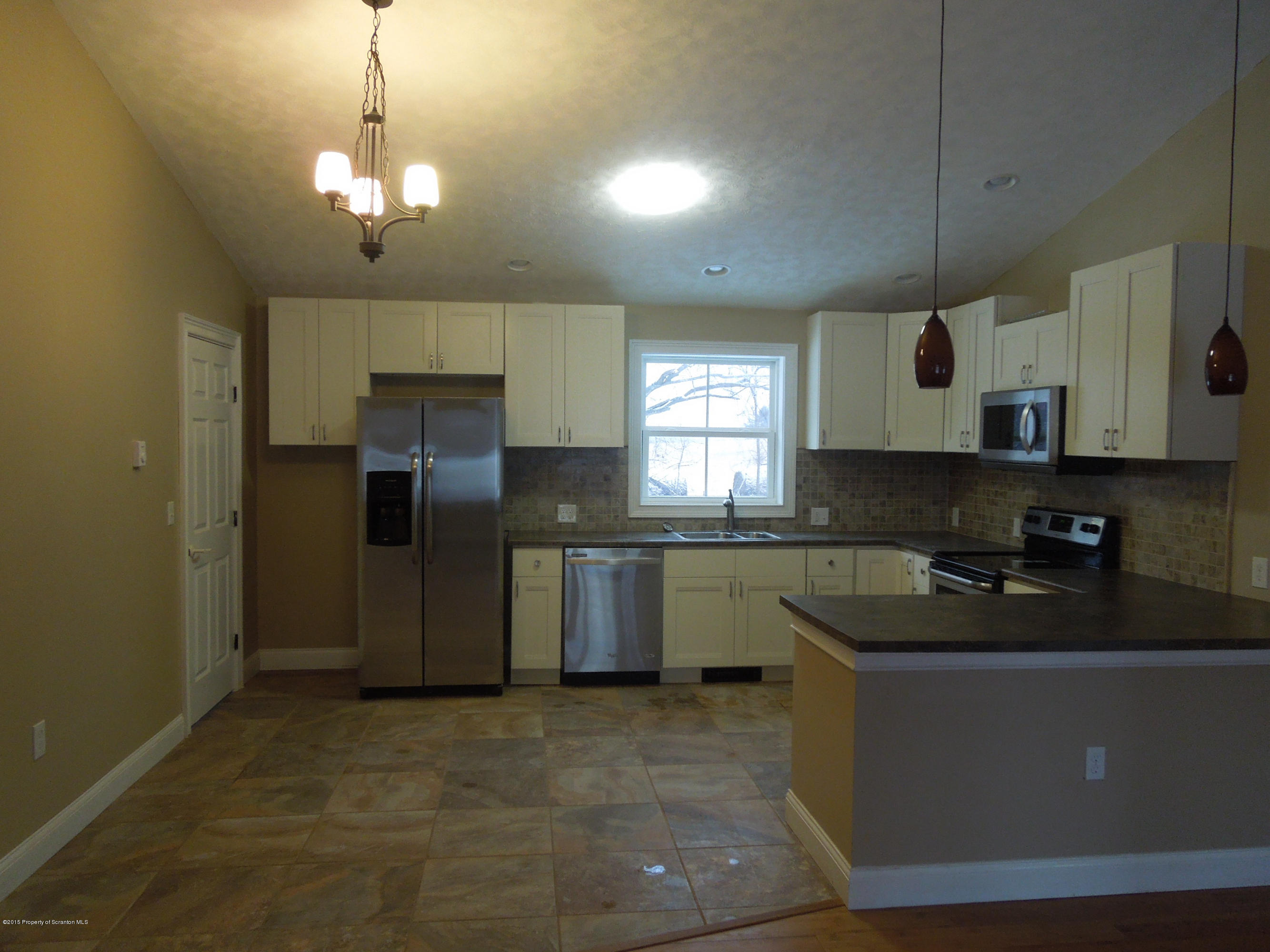 474 Fairview Road Dalton, PA 18414 - Photo 6 of 21 a kitchen with stainless steel appliances granite countertop a sink a stove a refrigerator cabinets and a counter top space
