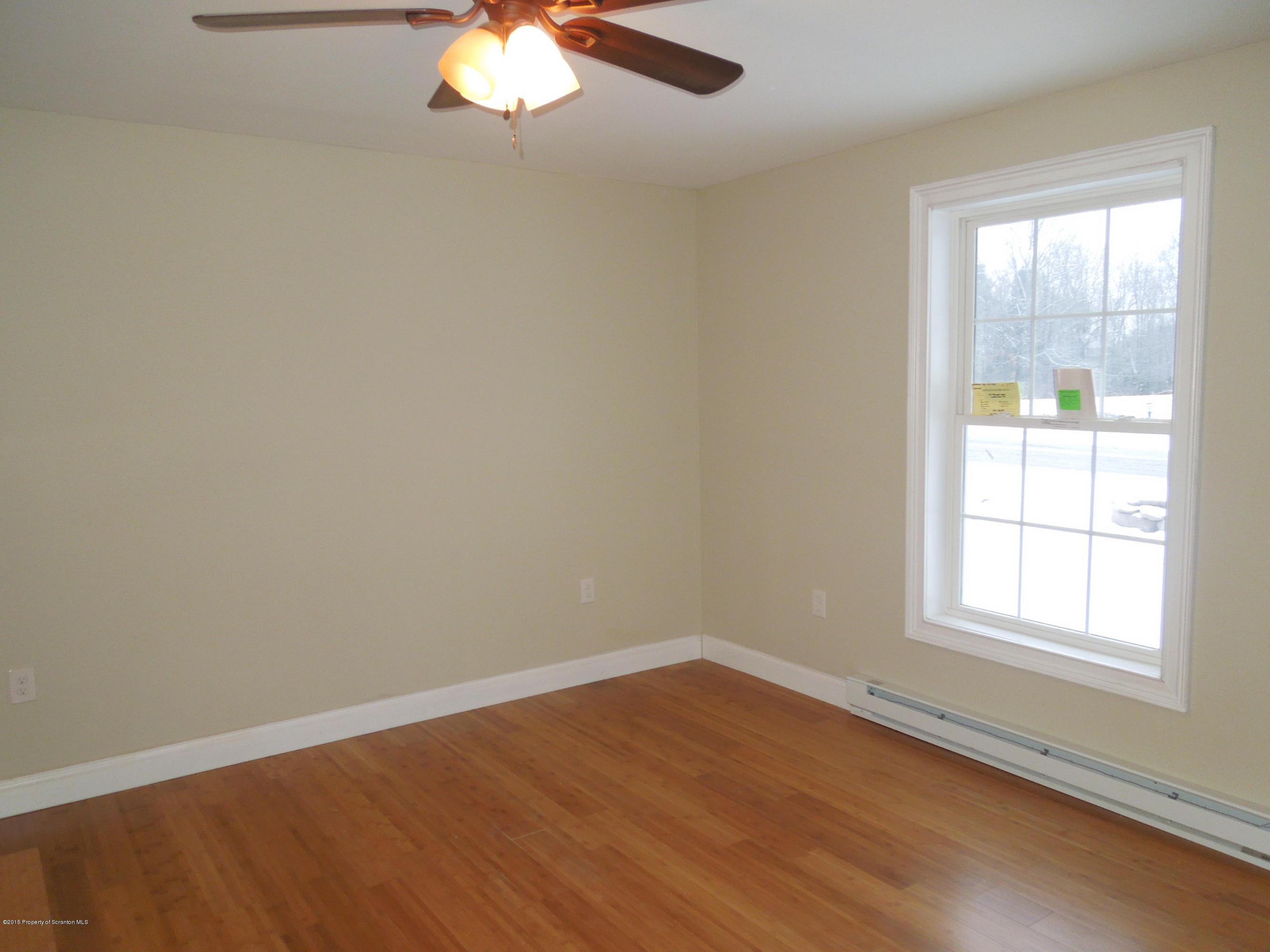 474 Fairview Road Dalton, PA 18414 - Photo 8 of 21 an empty room with wooden floor and windows