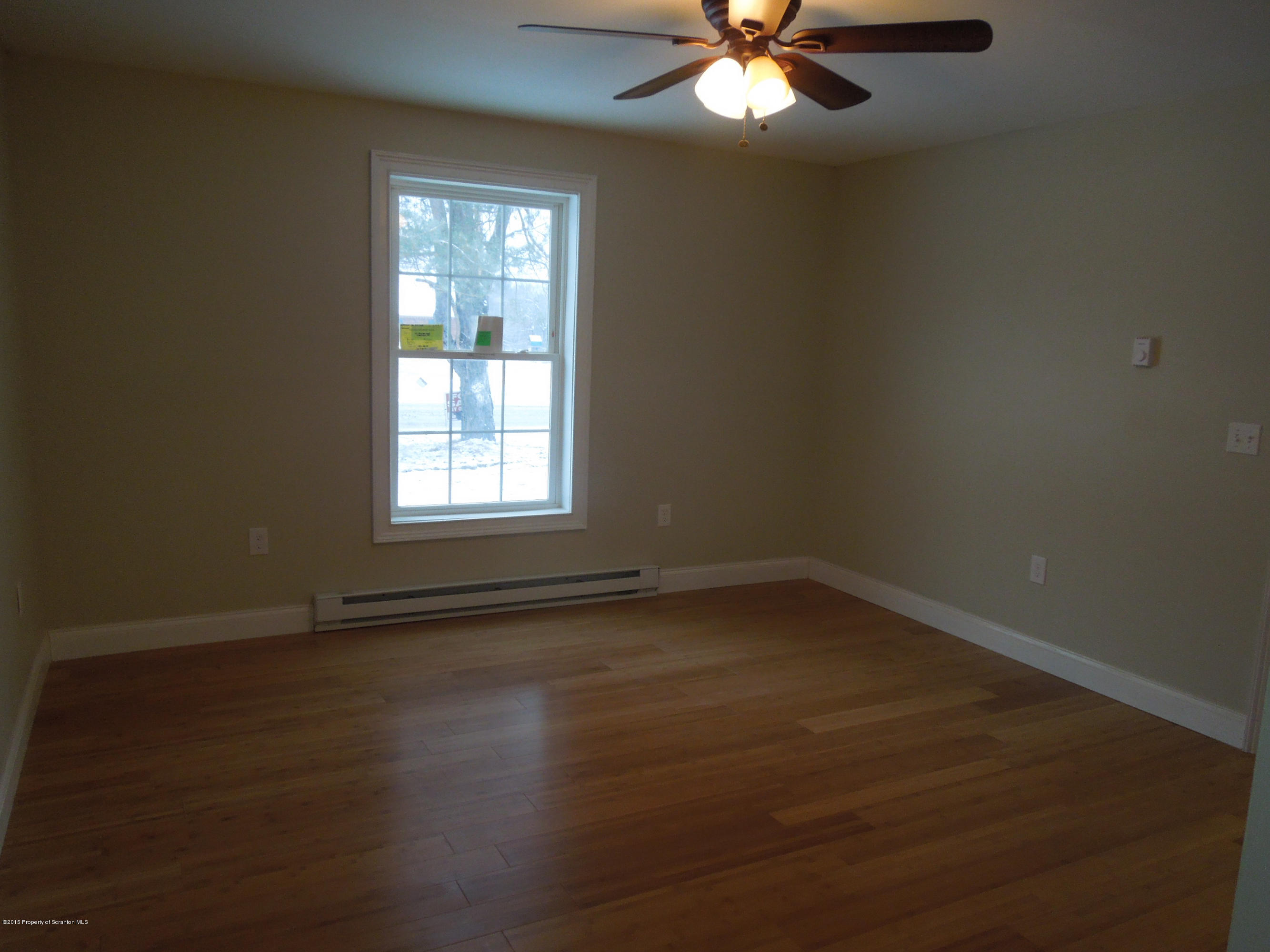 474 Fairview Road Dalton, PA 18414 - Photo 10 of 21 an empty room with wooden floor and windows