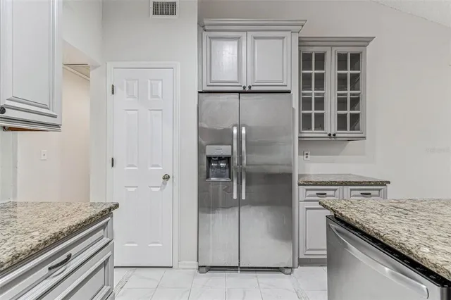 a view of a house with a yard and palm trees