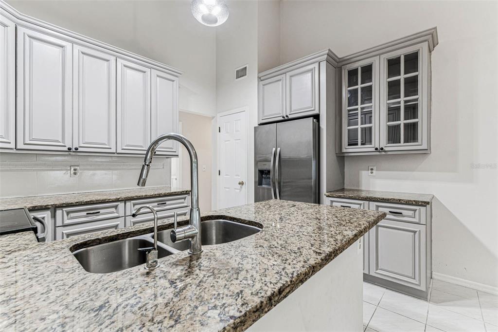 7206 Ridgeport Drive Tampa, FL 33647 - Photo 15 of 78 a kitchen with granite countertop a stove sink and refrigerator