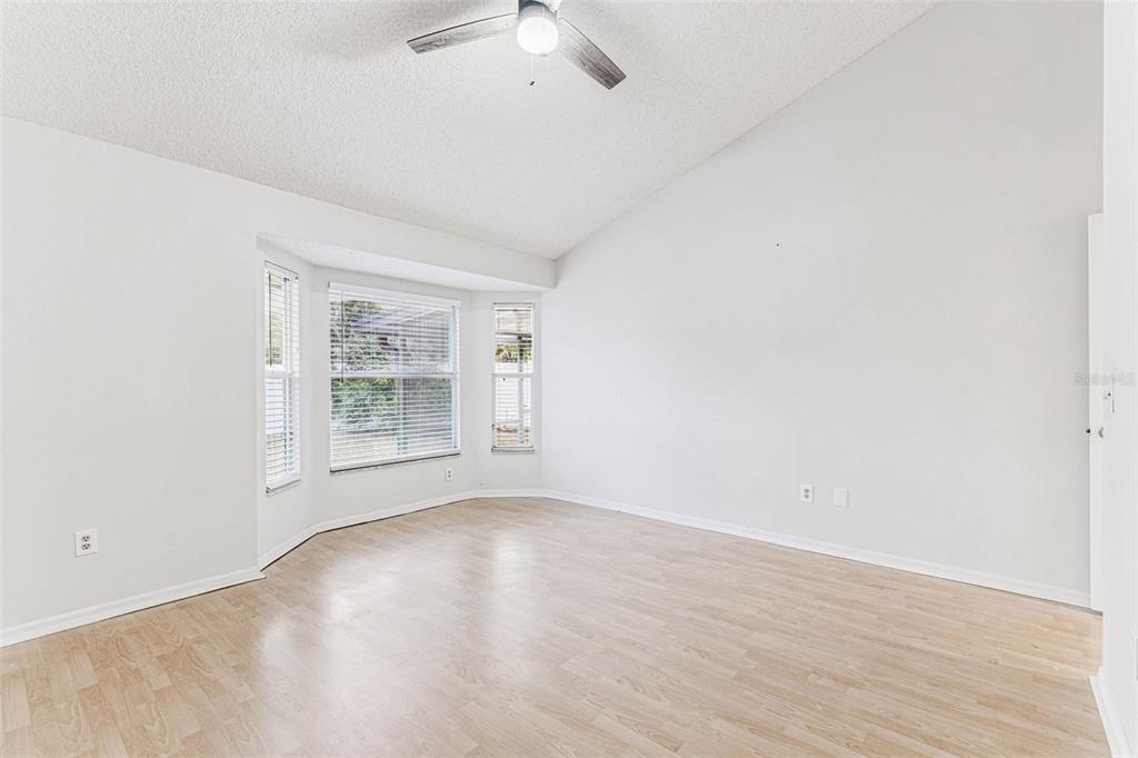 7206 Ridgeport Drive Tampa, FL 33647 - Photo 16 of 78 an empty room with wooden floor and windows
