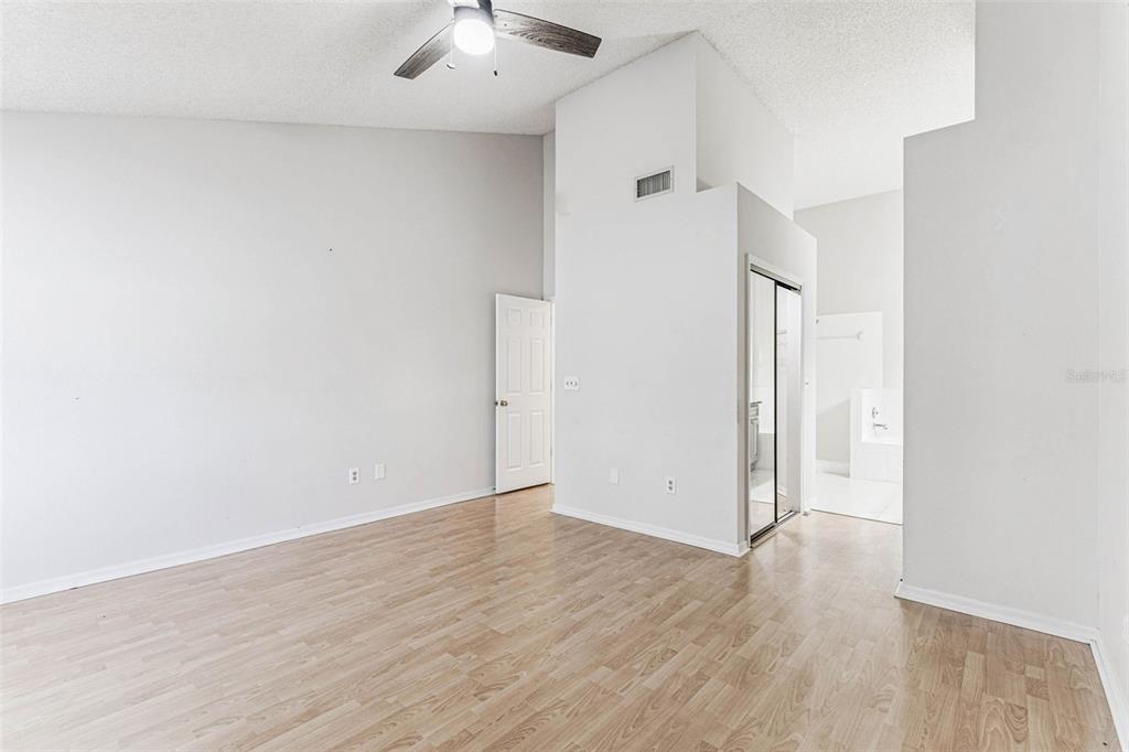 7206 Ridgeport Drive Tampa, FL 33647 - Photo 17 of 78 an empty room with wooden floor and ceiling fan