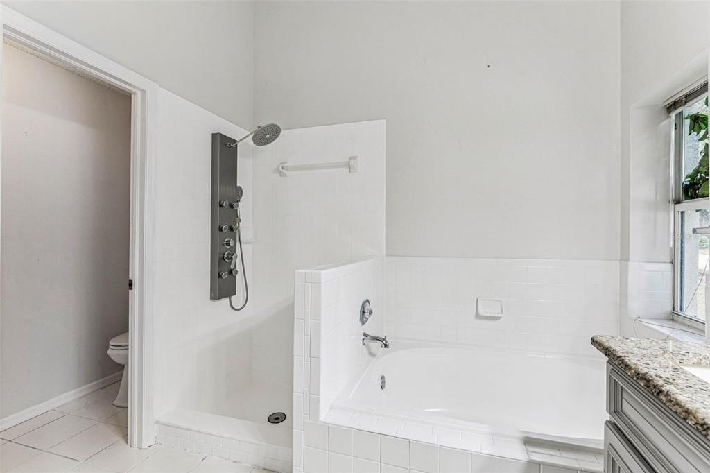 7206 Ridgeport Drive Tampa, FL 33647 - Photo 18 of 78 a bathroom with a tub and shower