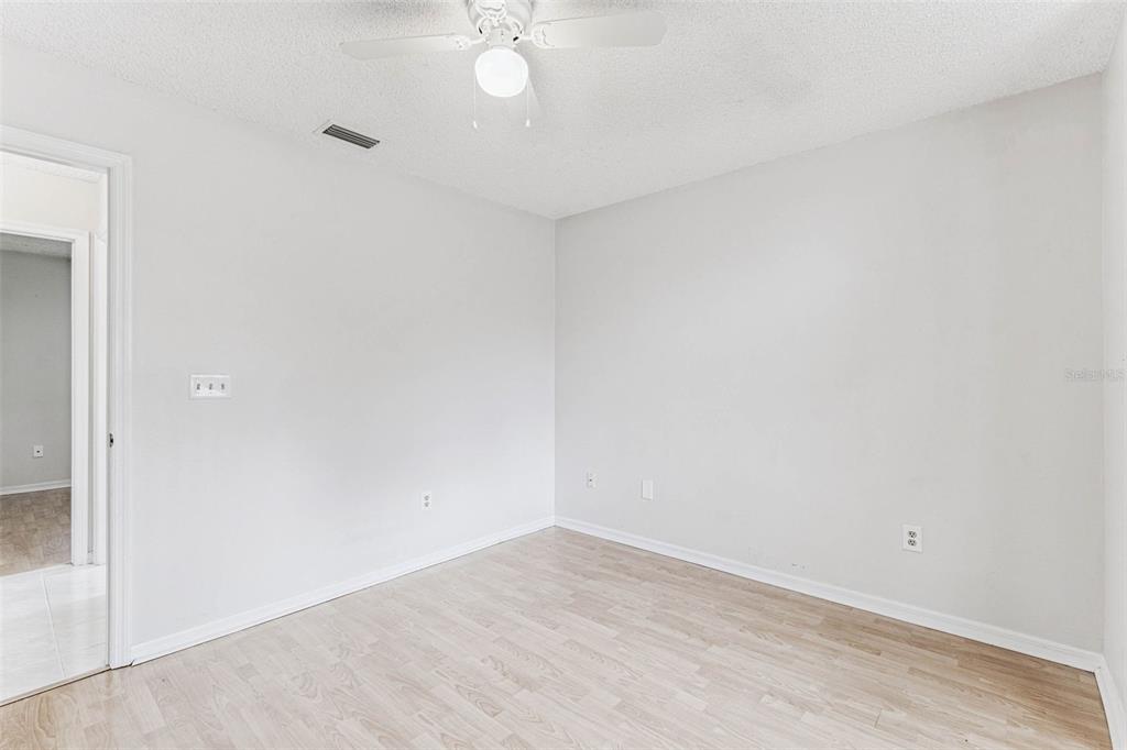 7206 Ridgeport Drive Tampa, FL 33647 - Photo 30 of 78 an empty room with a chandelier fan