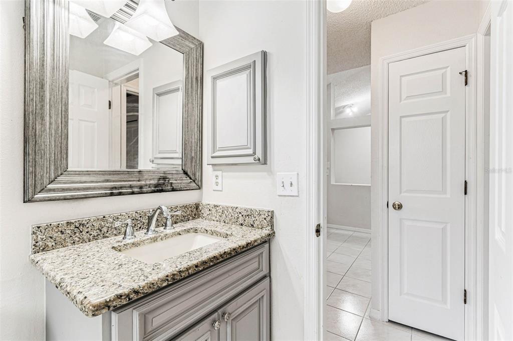 7206 Ridgeport Drive Tampa, FL 33647 - Photo 35 of 78 a bathroom with a granite countertop sink and a mirror