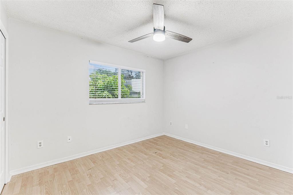 7206 Ridgeport Drive Tampa, FL 33647 - Photo 37 of 78 an empty room with a chandelier fan and windows
