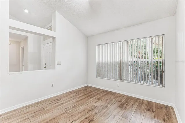 a bathroom with a granite countertop sink mirror and cabinets