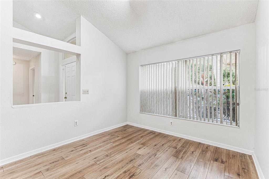 7206 Ridgeport Drive Tampa, FL 33647 - Photo 43 of 78 a view of an empty room with wooden floor and a window