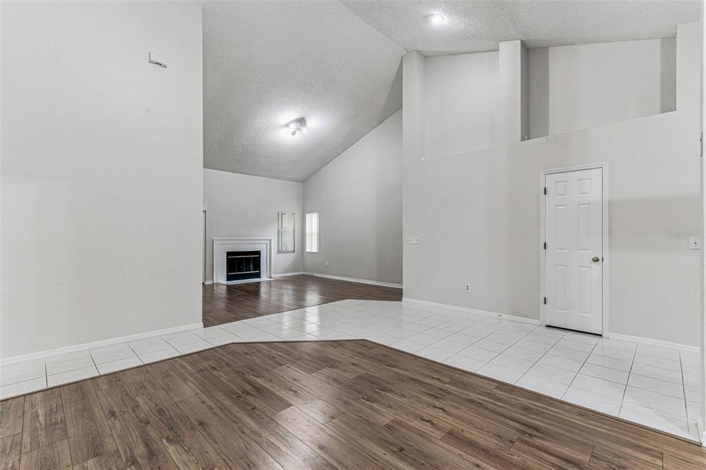 7206 Ridgeport Drive Tampa, FL 33647 - Photo 46 of 78 an empty room with wooden floor fireplace and windows
