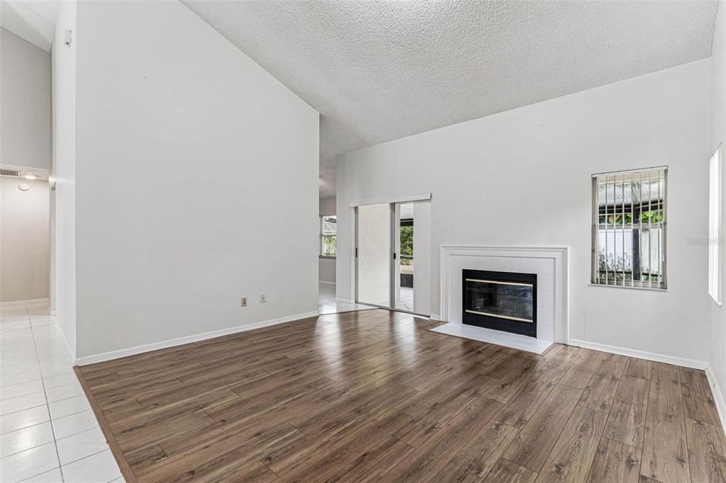 7206 Ridgeport Drive Tampa, FL 33647 - Photo 48 of 78 a view of an empty room with wooden floor fireplace and a window