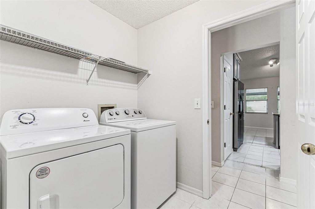7206 Ridgeport Drive Tampa, FL 33647 - Photo 57 of 78 a view of storage and utility room with washer and dryer