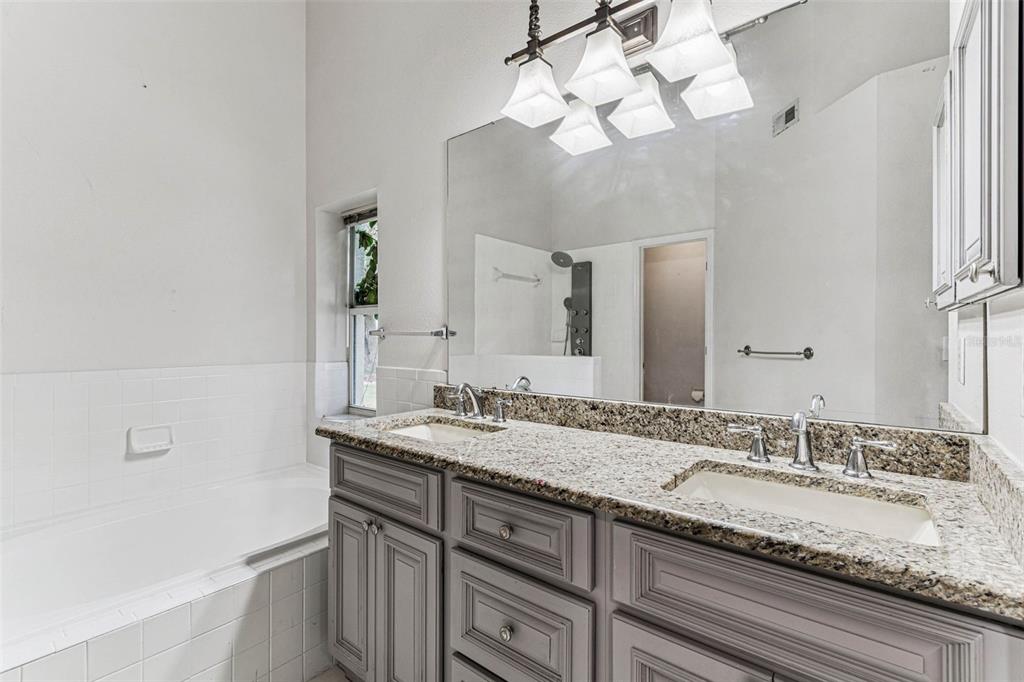7206 Ridgeport Drive Tampa, FL 33647 - Photo 61 of 78 a bathroom with a granite countertop sink and a mirror