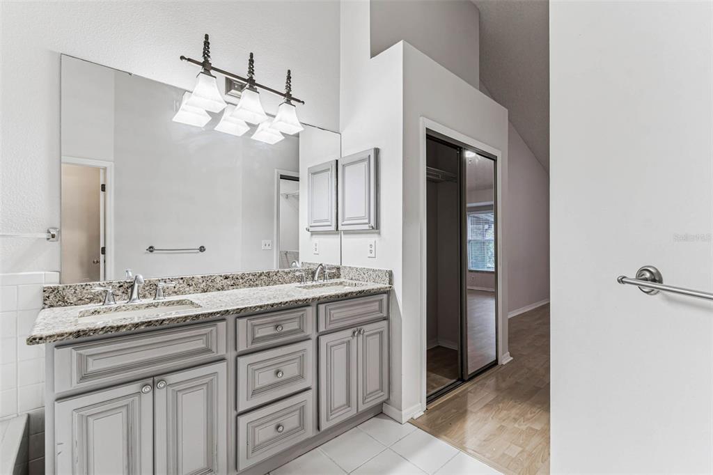7206 Ridgeport Drive Tampa, FL 33647 - Photo 62 of 78 a bathroom with a granite countertop sink mirror and cabinets