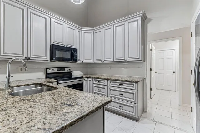 an empty room with wooden floor and ceiling fan