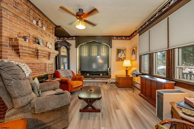 a bedroom with a bed dresser and flat screen tv