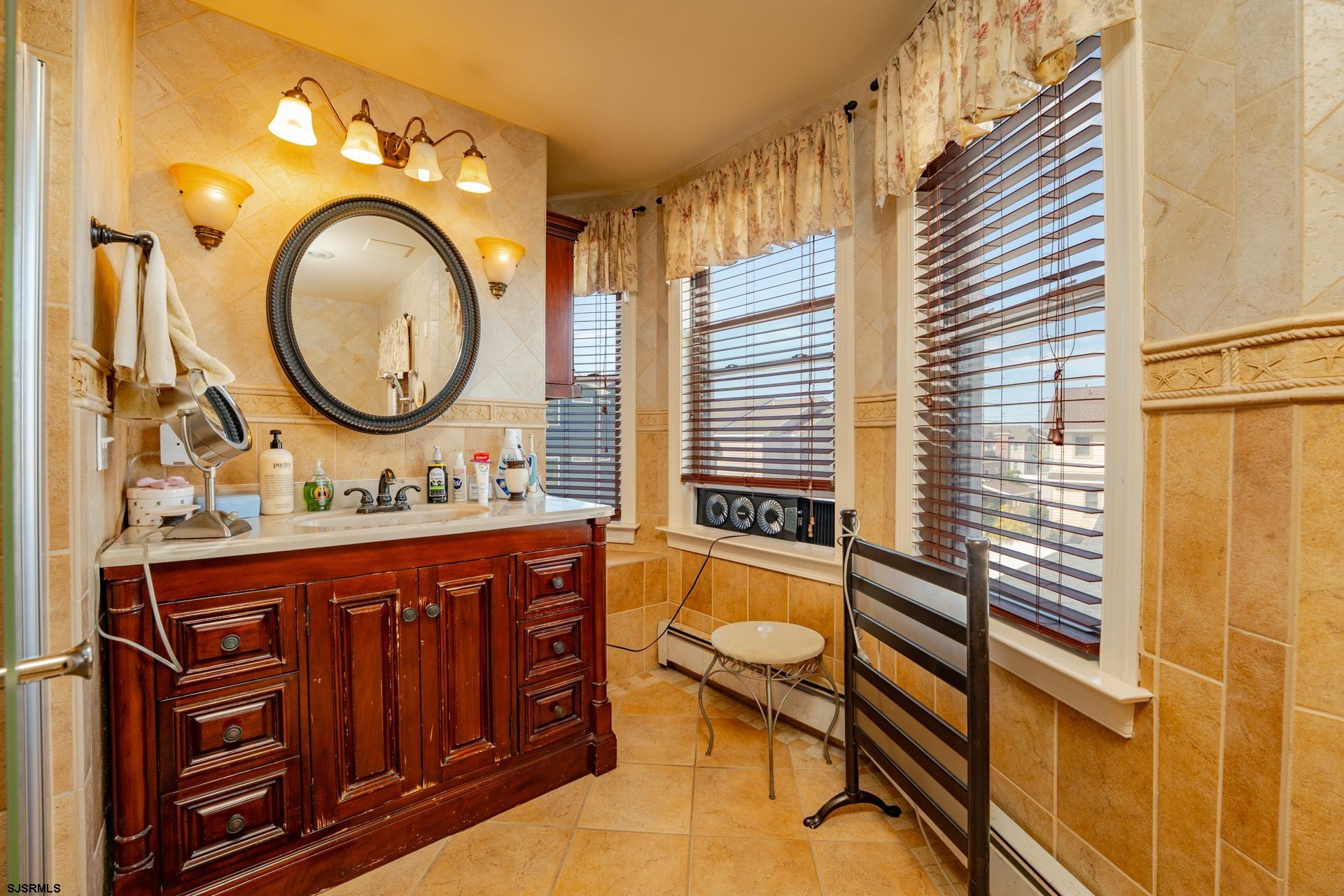 216 East Fern Road Wildwood Crest, NJ 08260 - Photo 39 of 93 a bathroom with a granite countertop sink mirror vanity and a bathtub