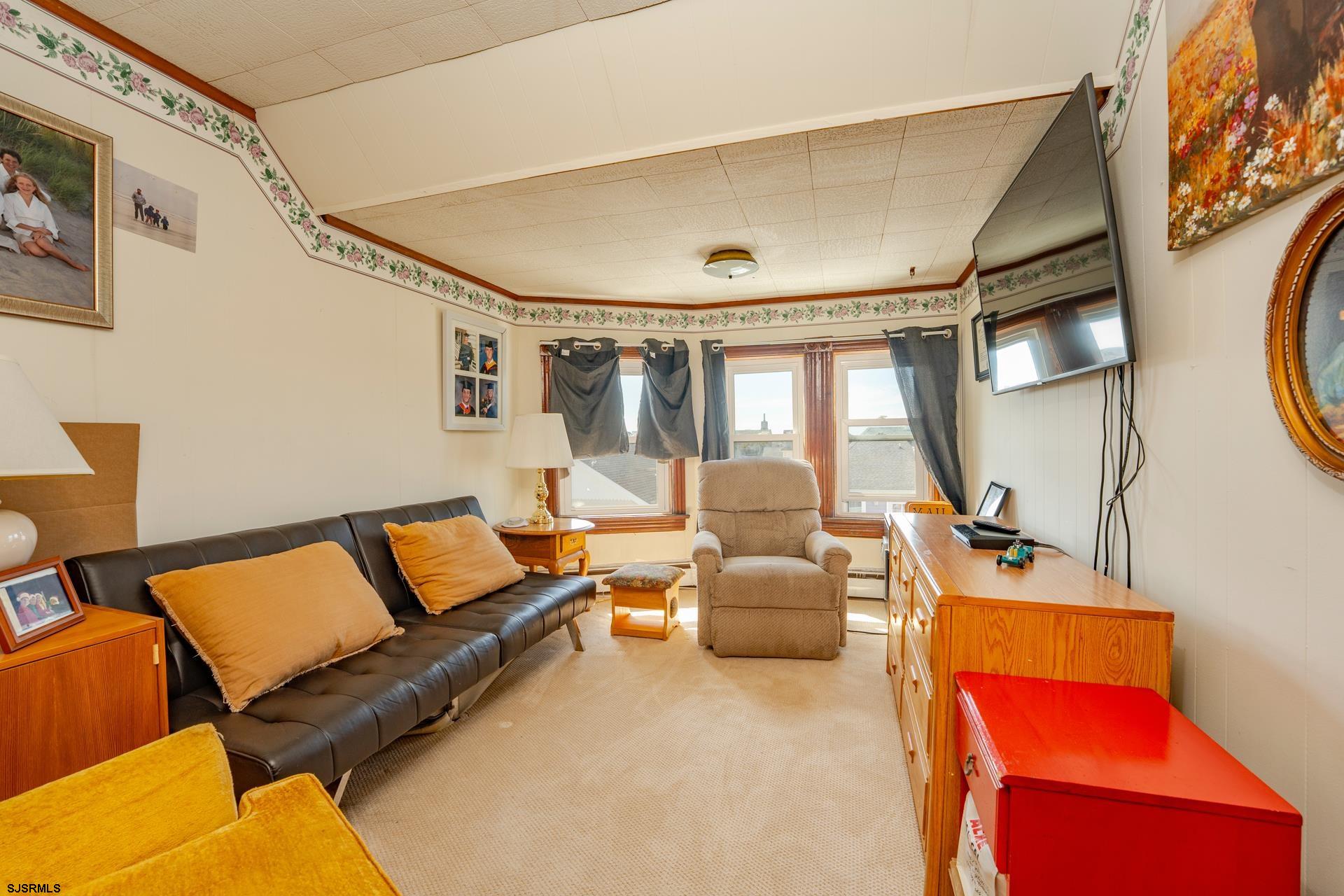 216 East Fern Road Wildwood Crest, NJ 08260 - Photo 56 of 93 a living room with furniture and a mirror