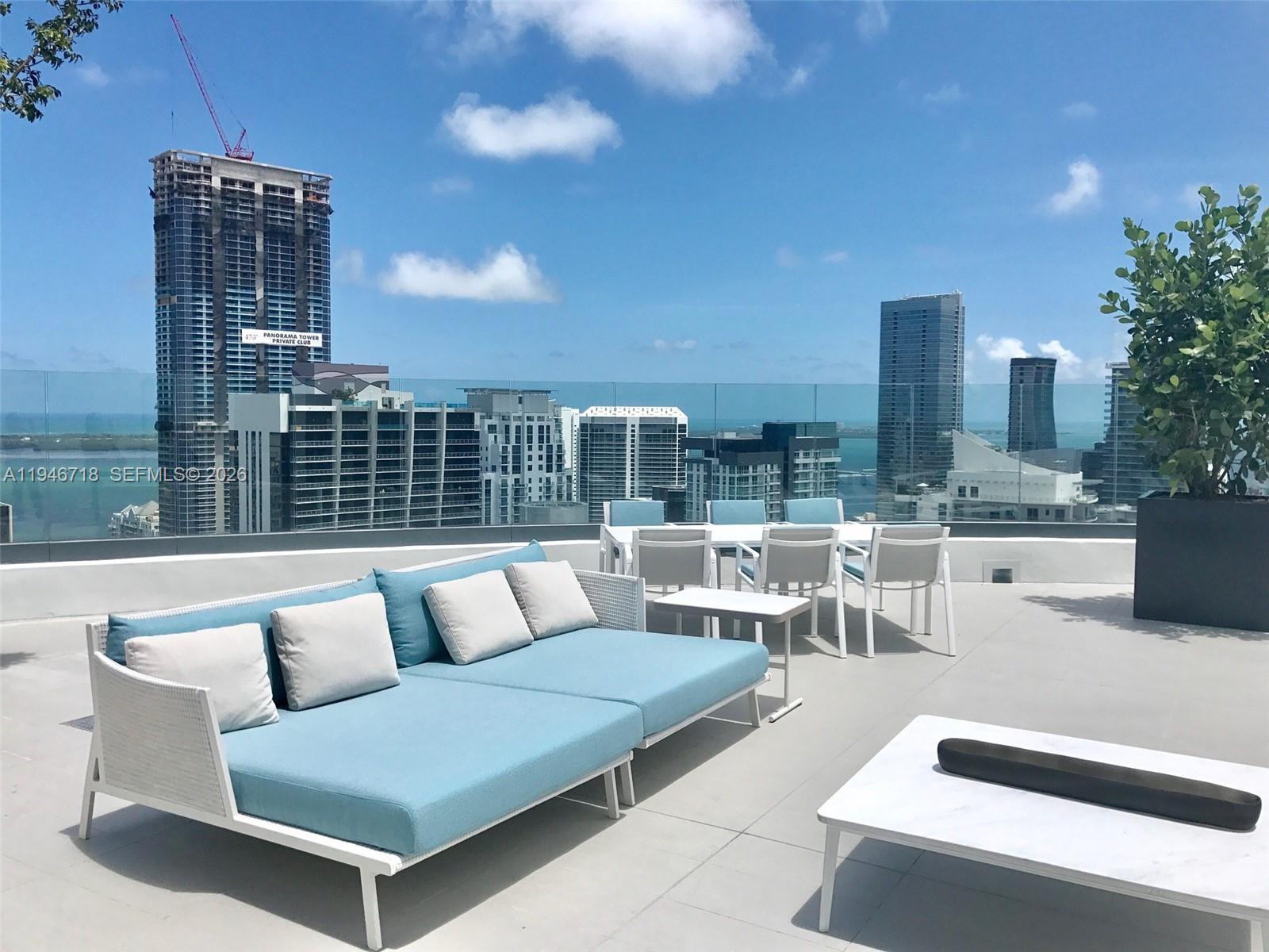 55 Southwest 9th Street, Unit 2807 Miami, FL 33130 - Photo 19 of 20 a roof deck with couches and potted plant