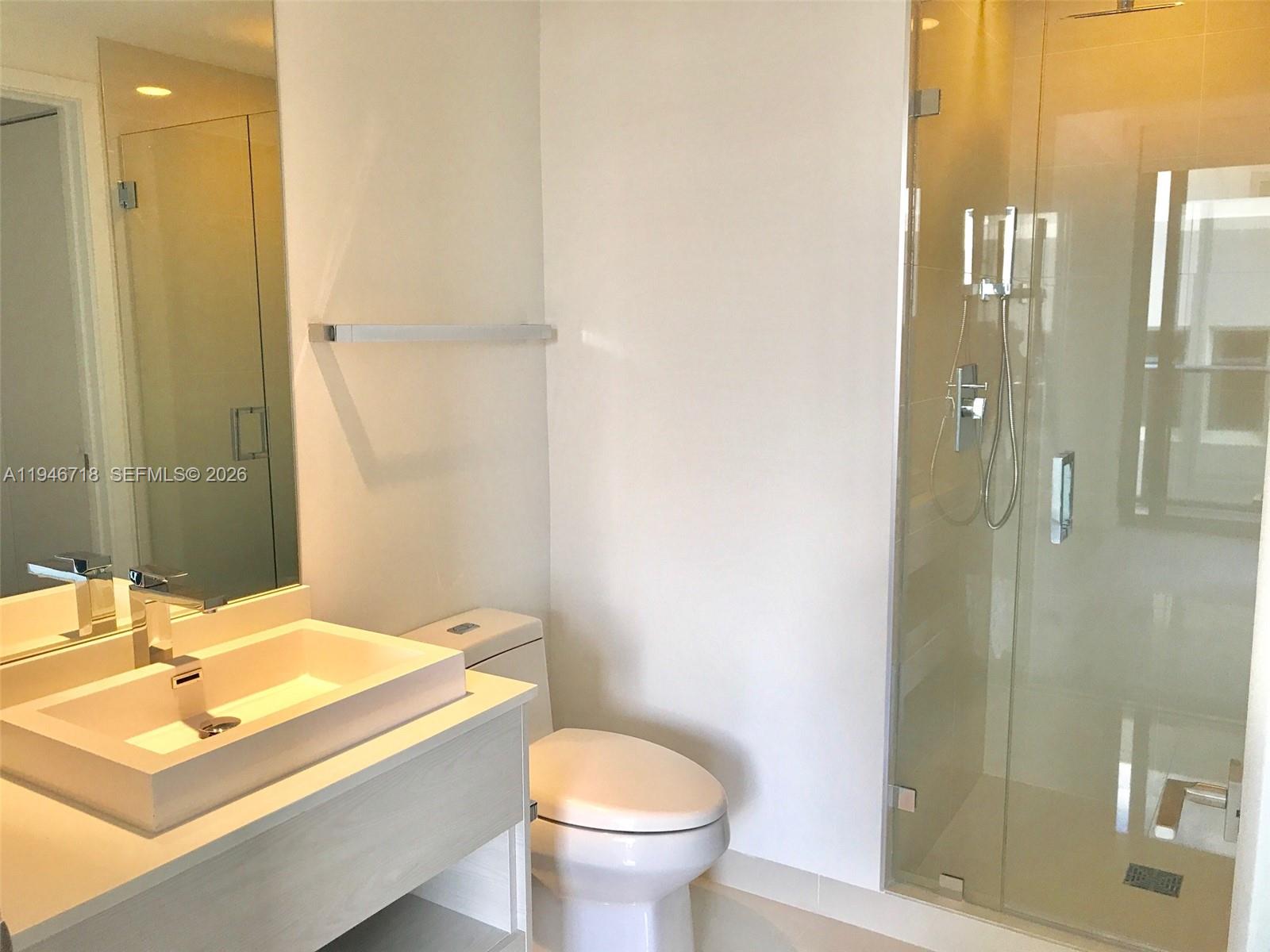 55 Southwest 9th Street, Unit 2807 Miami, FL 33130 - Photo 9 of 20 a bathroom with a sink toilet and shower