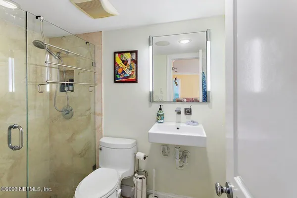 a bathroom with a sink toilet and shower