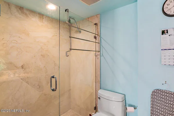 a bathroom with a shower and a toilet