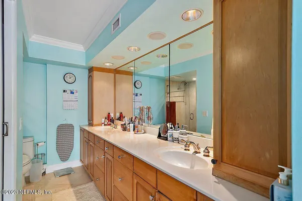 a bathroom with a double vanity sink mirror and shower